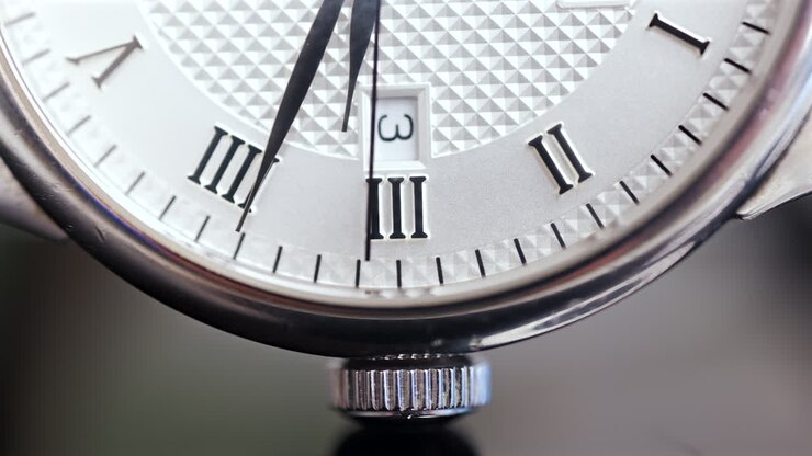 Close up of a silver watch on a blurred background