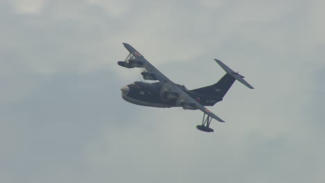 Fly-by-of-a-japanese-amphibious-plane-in-wide-angle-left-to-right