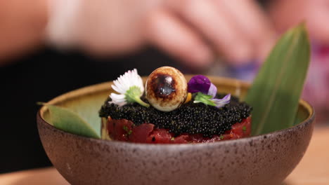 garnishing a delicious bowl of caviar and tuna - close up