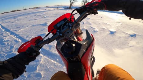 snowbike pov jumping out of snowy ravine at sunset