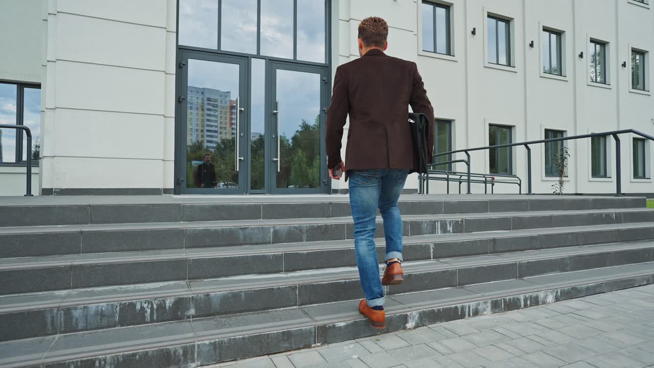 Man walking down stairs outside office building