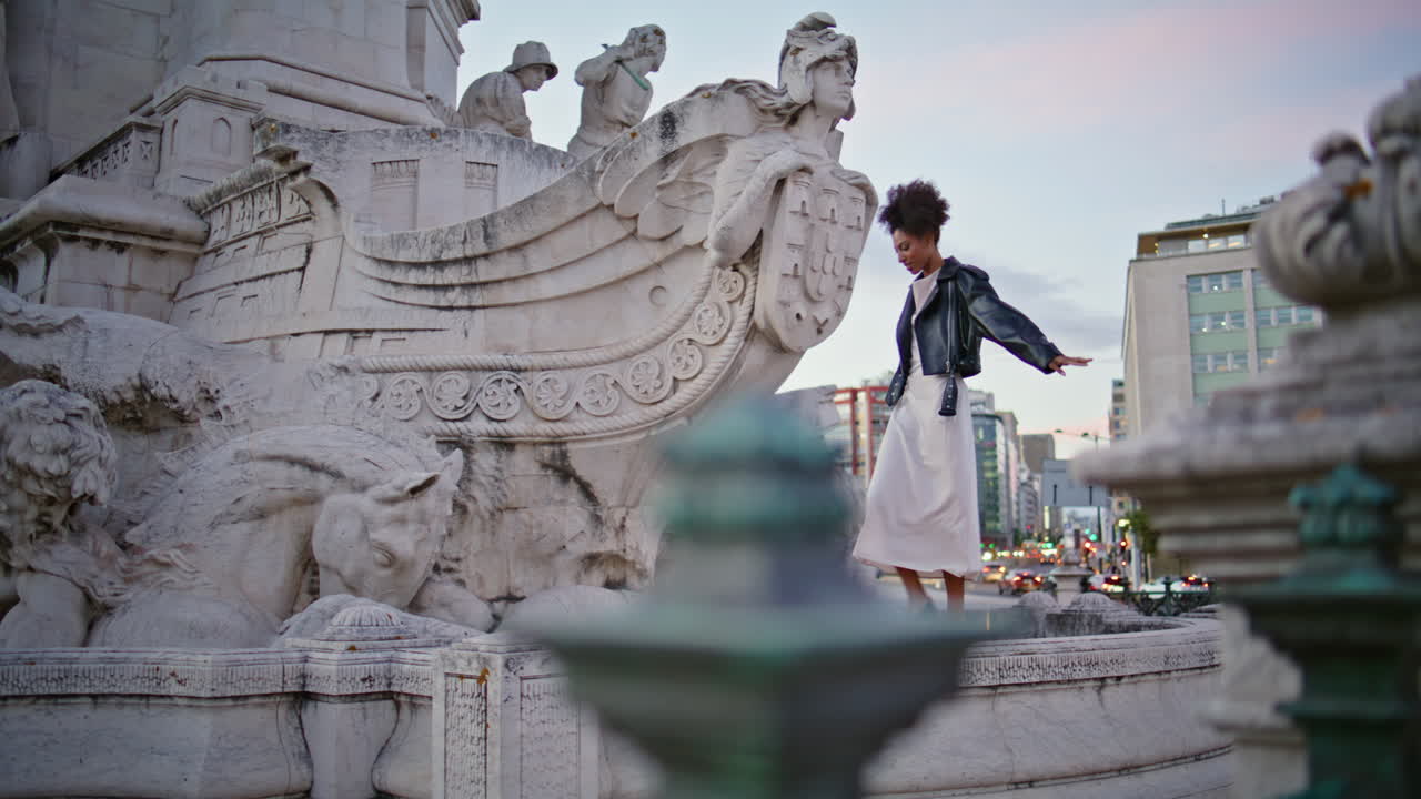Happy woman walking monument in evening city. lady tourist