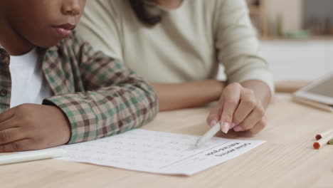 mother helping child with math homework