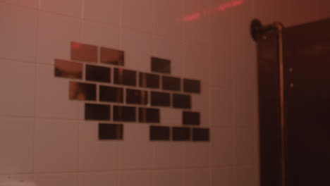 beautiful girl looking at mirror in bar bathroom