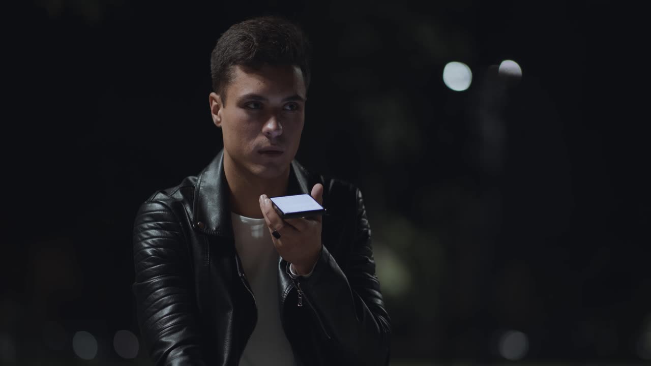 Young man using smartphone at night