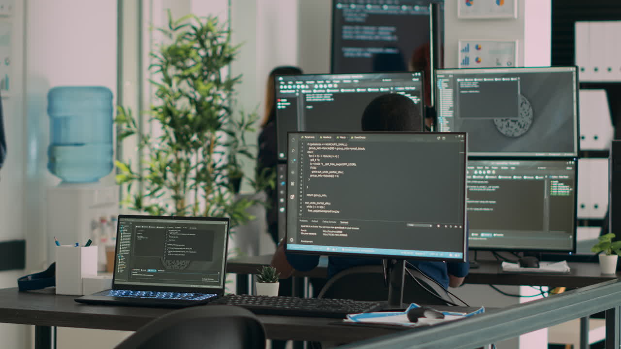 Multiethnic group of programers working on server code to develop new database