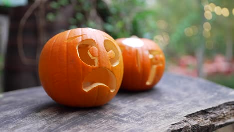 two carved pumpkins with worried faces for halloween