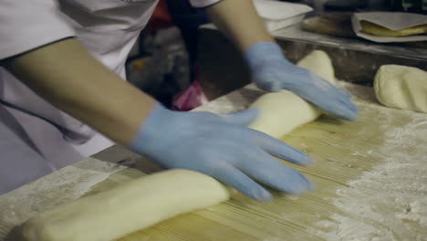 Rolling-dough-and-cut-it-into-pieces.-Preparing-dough-for-baking.-Making-dough