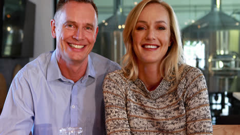 happy couple holding glasses of beer in bar 4k