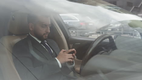 office worker talking on phone in car