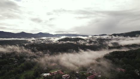 Aerial-Flight-above-clouds-and-mountains-over-Valle-De-Bravo,-Mexico