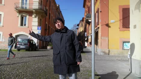 Man Pointing in European City Street