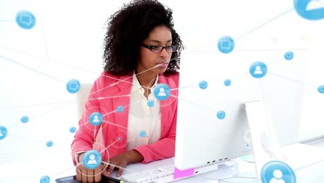 Animation-of-network-of-digital-icons-on-african-american-businesswoman-using-computer-taking-notes