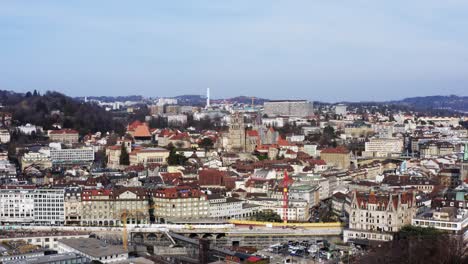 Intro-shot-of-Cathedral-in-Lausanne-Switzerland-city-with-construction-tower-cranes