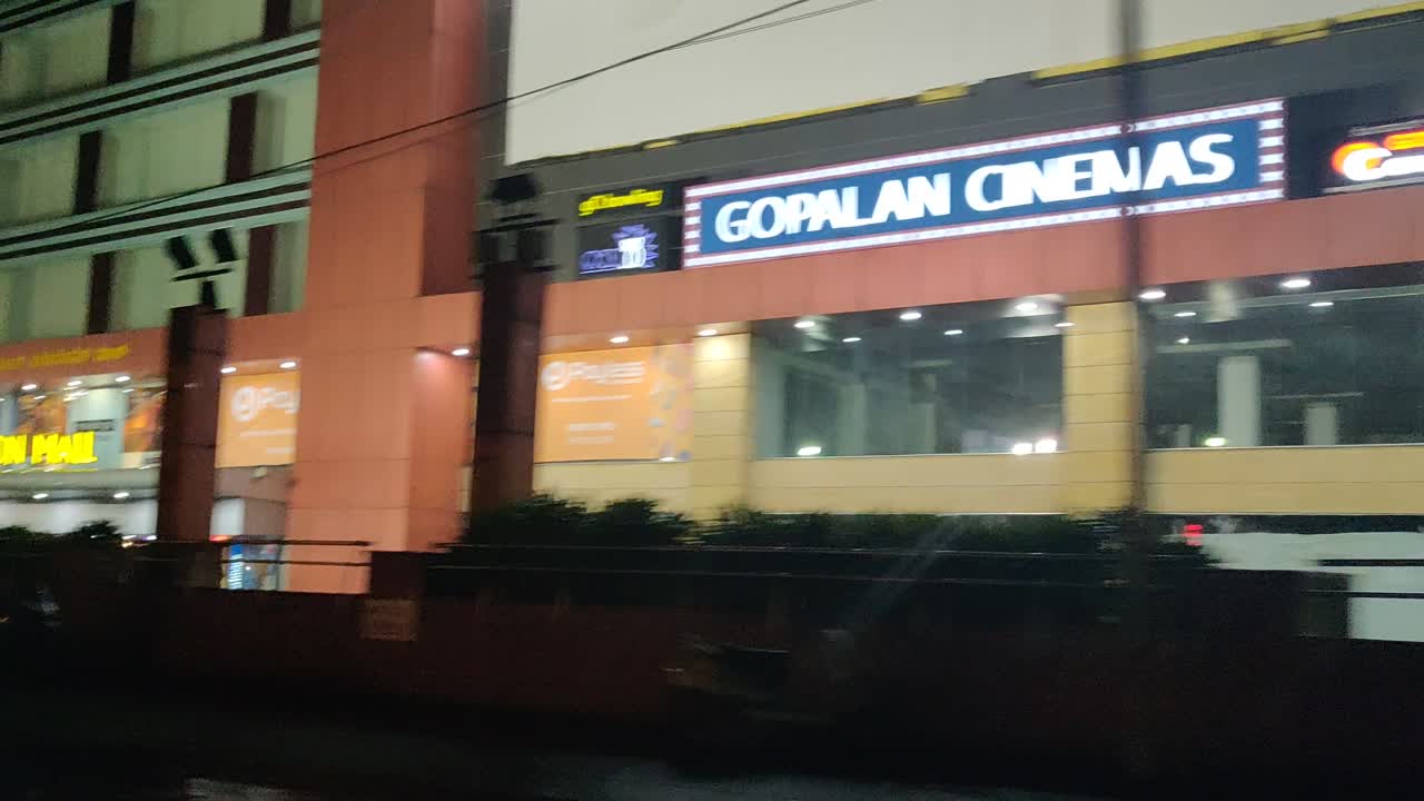 Night view of Gopalan Innovation Mall with Payless signage