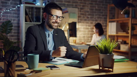 man working late at night on laptop in office