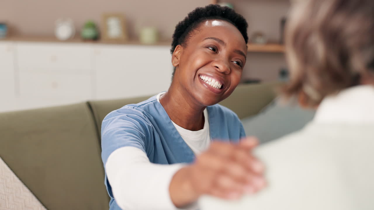 A caring caregiver supports an elderly patient at home