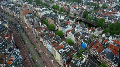 drone flies forward over streets and canal in amsterdam (60fps)