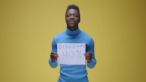happy man holding 'discount 40%' sign