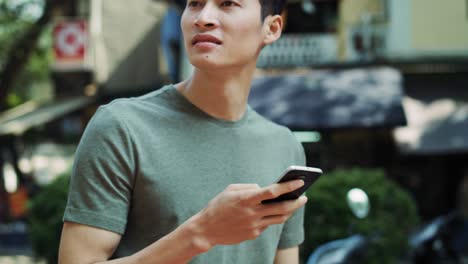 handheld view of tourist with mobile phone in the city