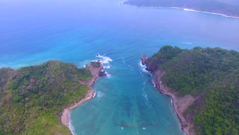 aerial video flying up and out away from a divide in an archipelago chains of islands off the coast of costa rica in central america