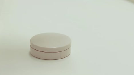 close up to hands struggling to pry open a contact lens container