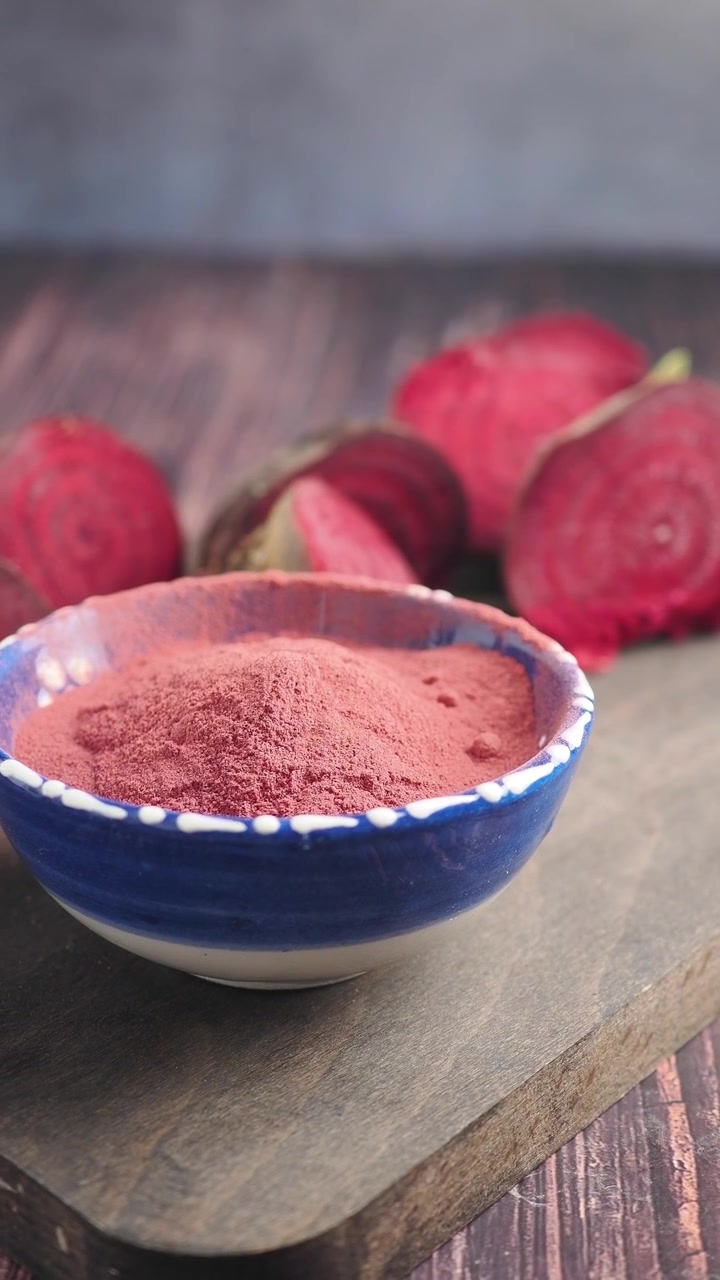 Beetroot Powder in Bowl with Fresh Beets on Wooden Board