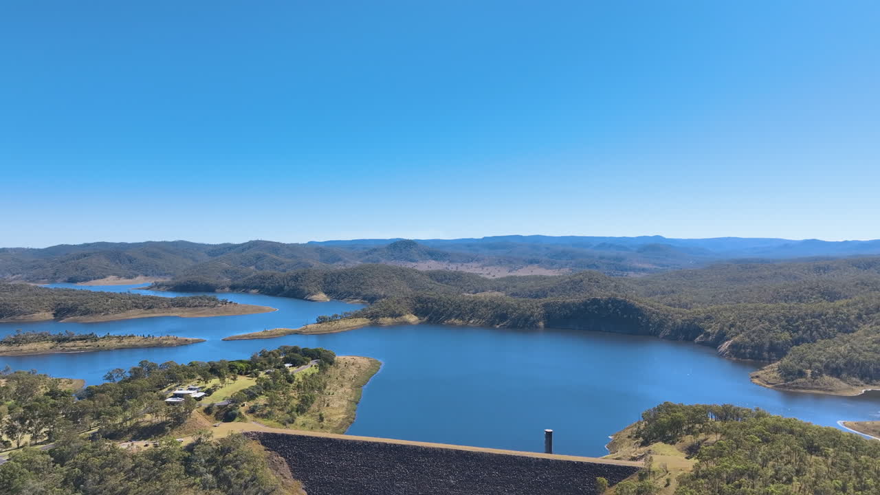 Flying above the steep walls of Queensland's Cania Dam and the headlands of Three Moon Creek, cottages and, rich national park forests, Monto, Burnett region, Queensland, Australia.