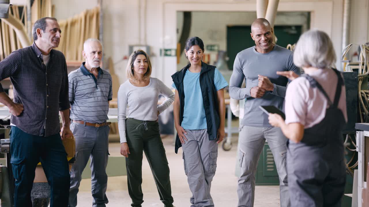 Diverse Group of Workers Having a Meeting in a Workshop