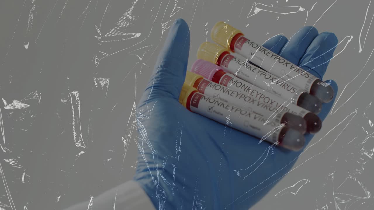 Gloved male hand rotating wrist in lab, tilting tubes revealing labels through plastic film