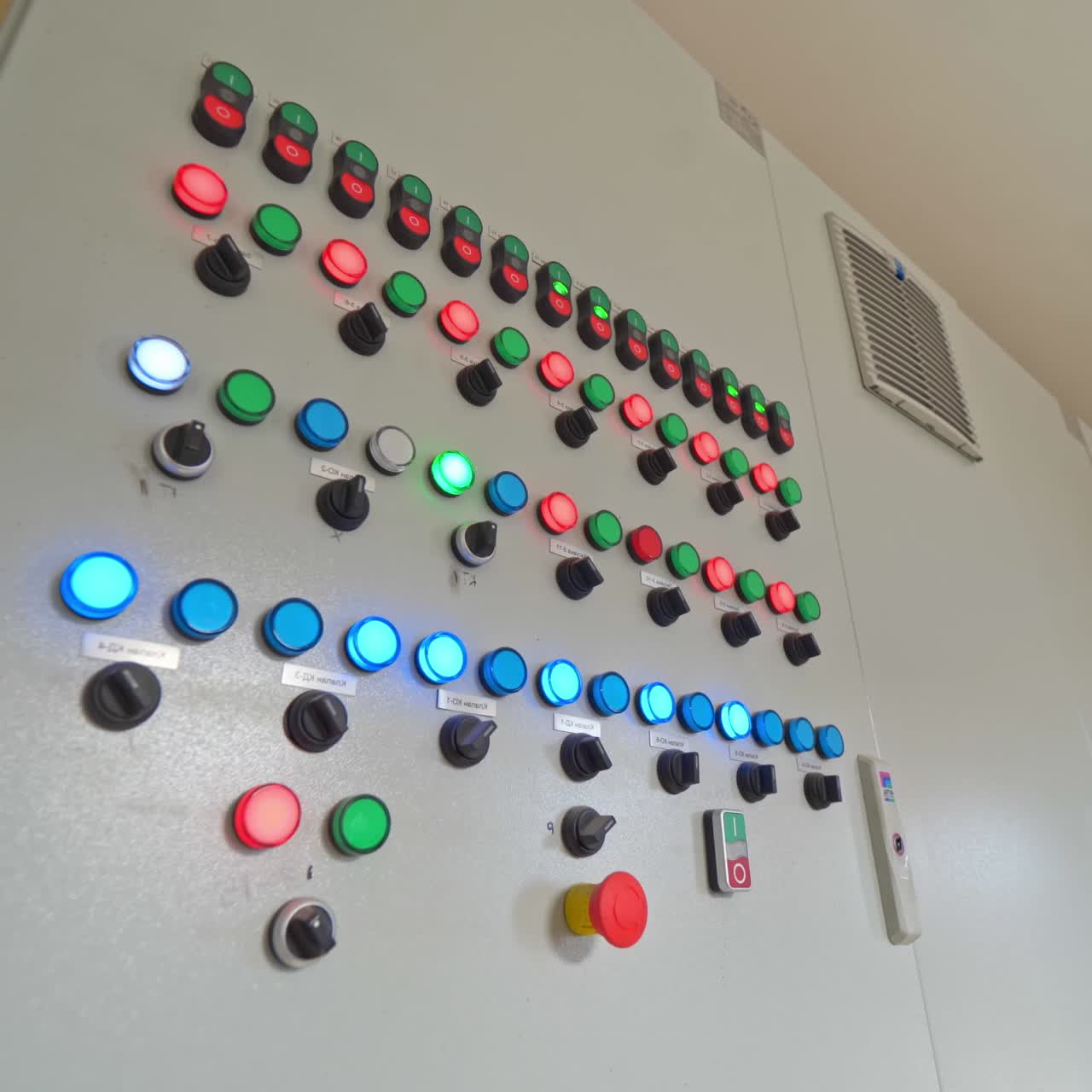 Automated panel with glowing buttons. Control buttons inside the modern industrial plant. Industrial equipment indoors