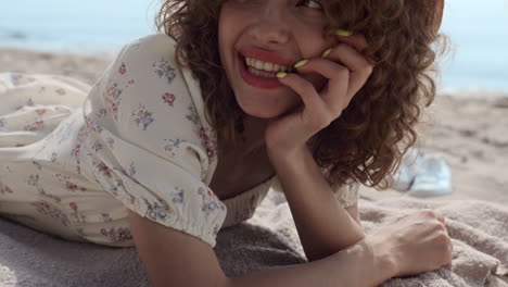 portrait smiling girl lying on beach sand summer day. lady relax on seashore.