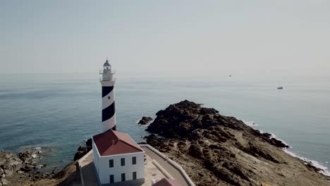 aerial view of favaritx lighthouse on the mediterranean island of menorca in spain - drone shot