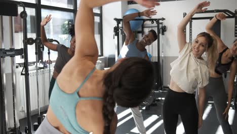 group stretching exercise class in gym