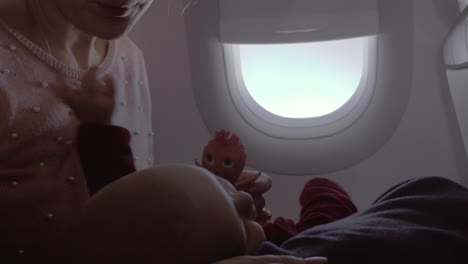 mum playing with baby in the airplane