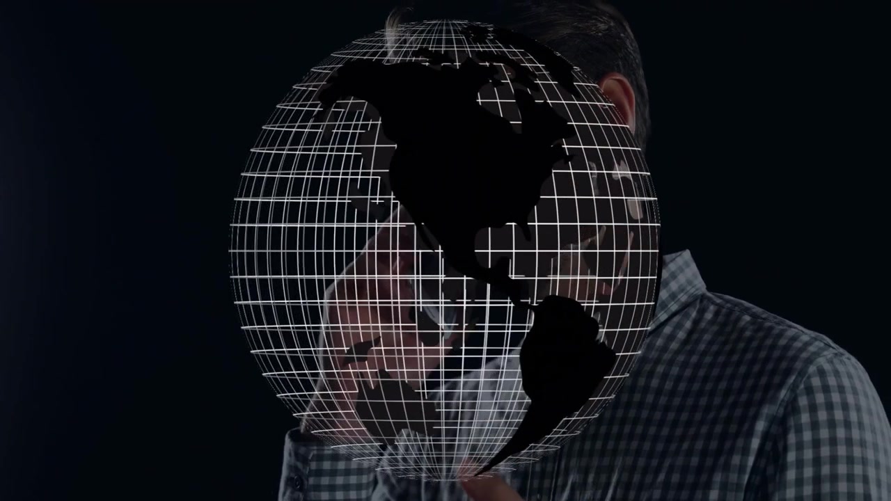Uomo con un globo olografico in uno studio tecnologico, che mostra una mappa wireframe delle Americhe