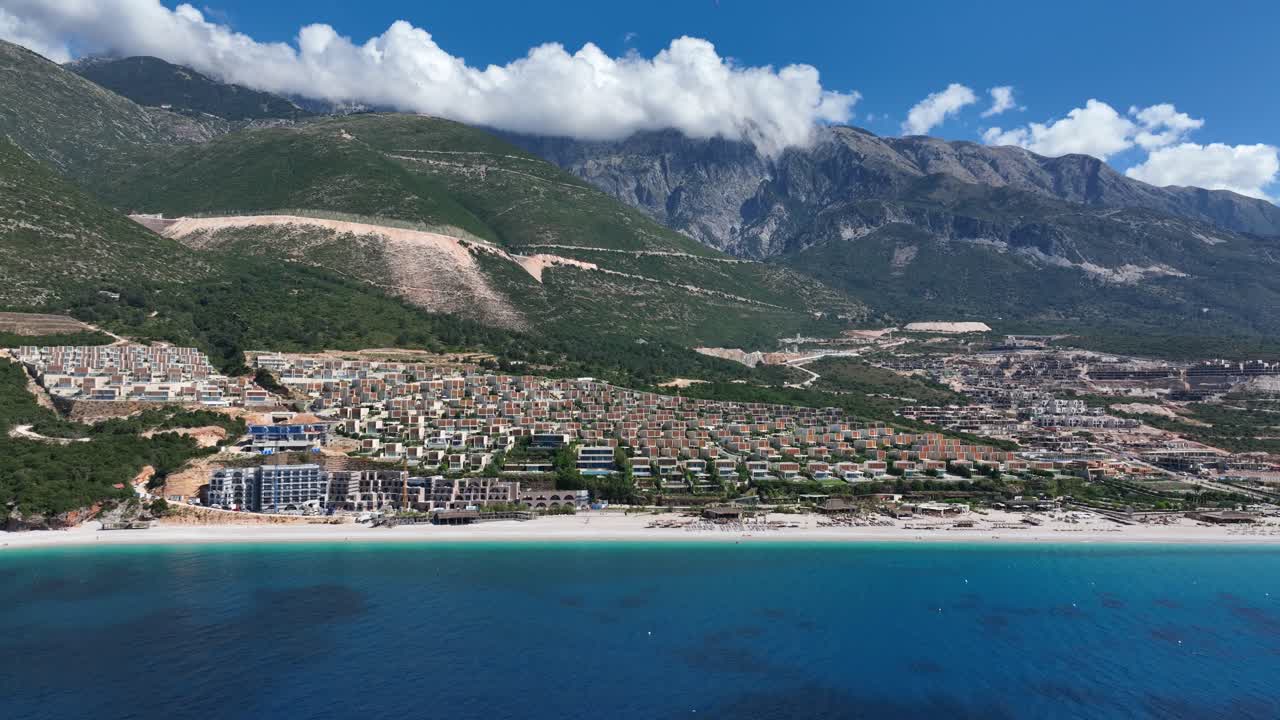 Expansive aerial panoramic view of the Palase Green Coast resort and apartment community in the Palasë region of Albania, showcasing its stunning coastline, modern architecture.