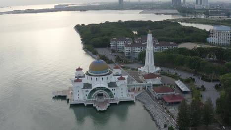 aerial drone establishing b-roll footage of melaka straits floating mosque during sunset