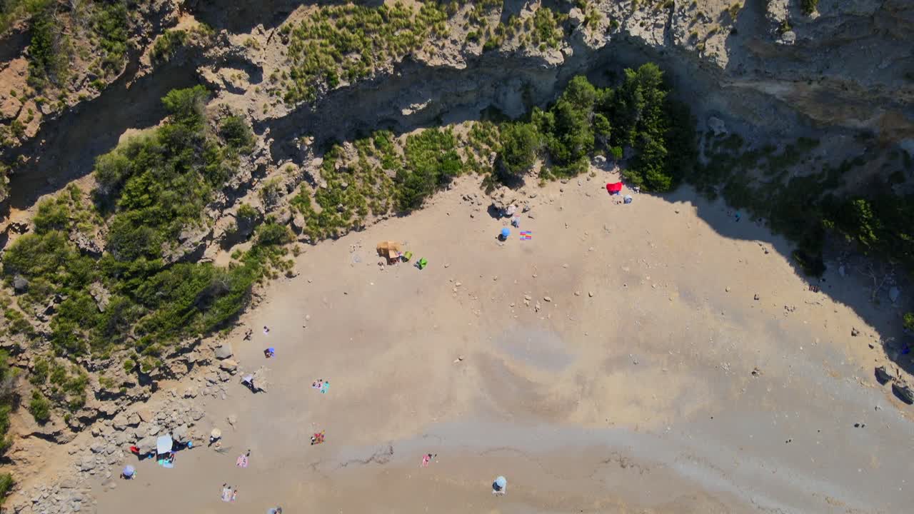 Coll Baix beach showcases the natural beauty of Mallorca, inviting visitors to relax on the sand beneath clear skies. The tranquil waters create a perfect spot for sunbathing and swimming.