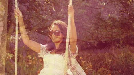 woman on a swing and sunlit trees