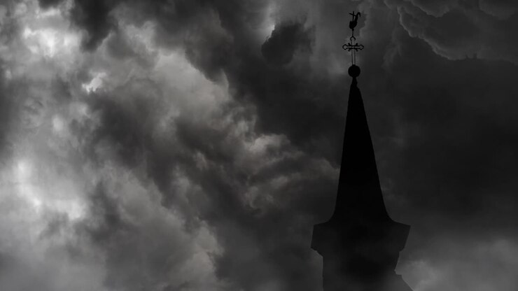 the top of the church roof against a background of storm clouds