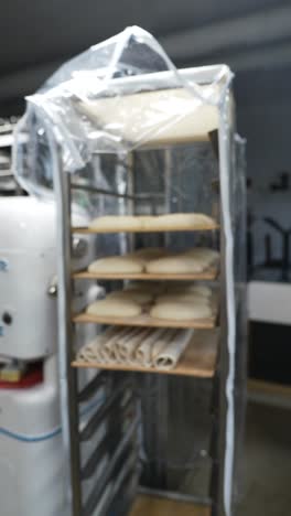 raw dough on racks in a commercial bakery