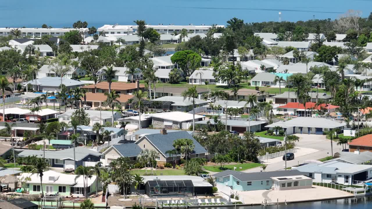 Luxury houses and homes between palm trees in Cortez, Florida. Sunny day in noble district with residences. Aerial zoom shot. Sunny day in summer.