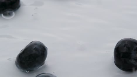 Blueberries-Splashing-into-water,-Macro-shot-Slow-motion---Fresh-healthy-fruit