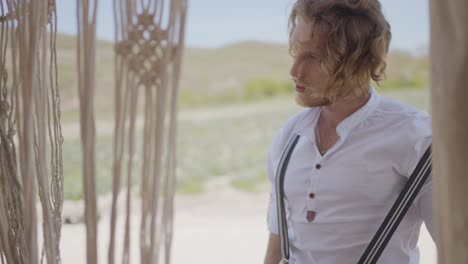 man in a white shirt in a rustic outdoor setting