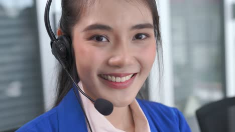 businesswoman wearing headset working actively in office