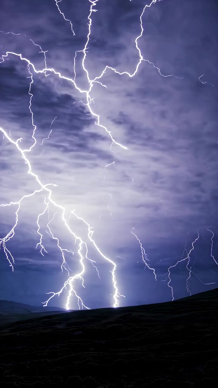 Intense Lightning Strikes Over Dark Landscape at Night