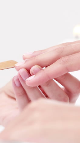 woman getting a manicure at nail salon