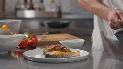 serving salmon steak and asian style vegetables on plate
