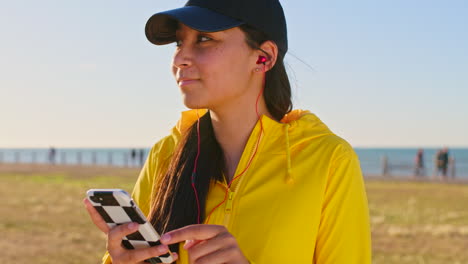 woman using phone on beach